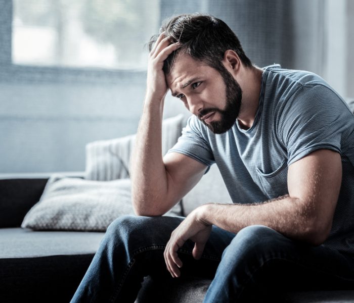 Unpleasant,Pain.,Sad,Unhappy,Handsome,Man,Sitting,On,The,Sofa